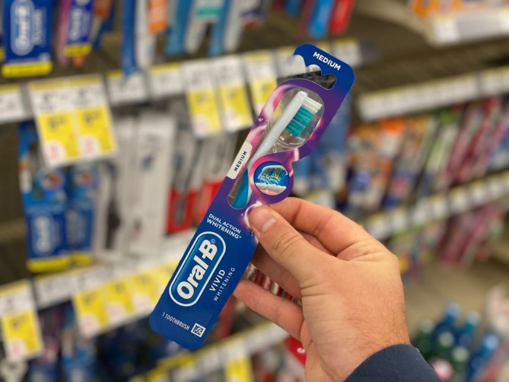 hand holding an oral-b toothbrush