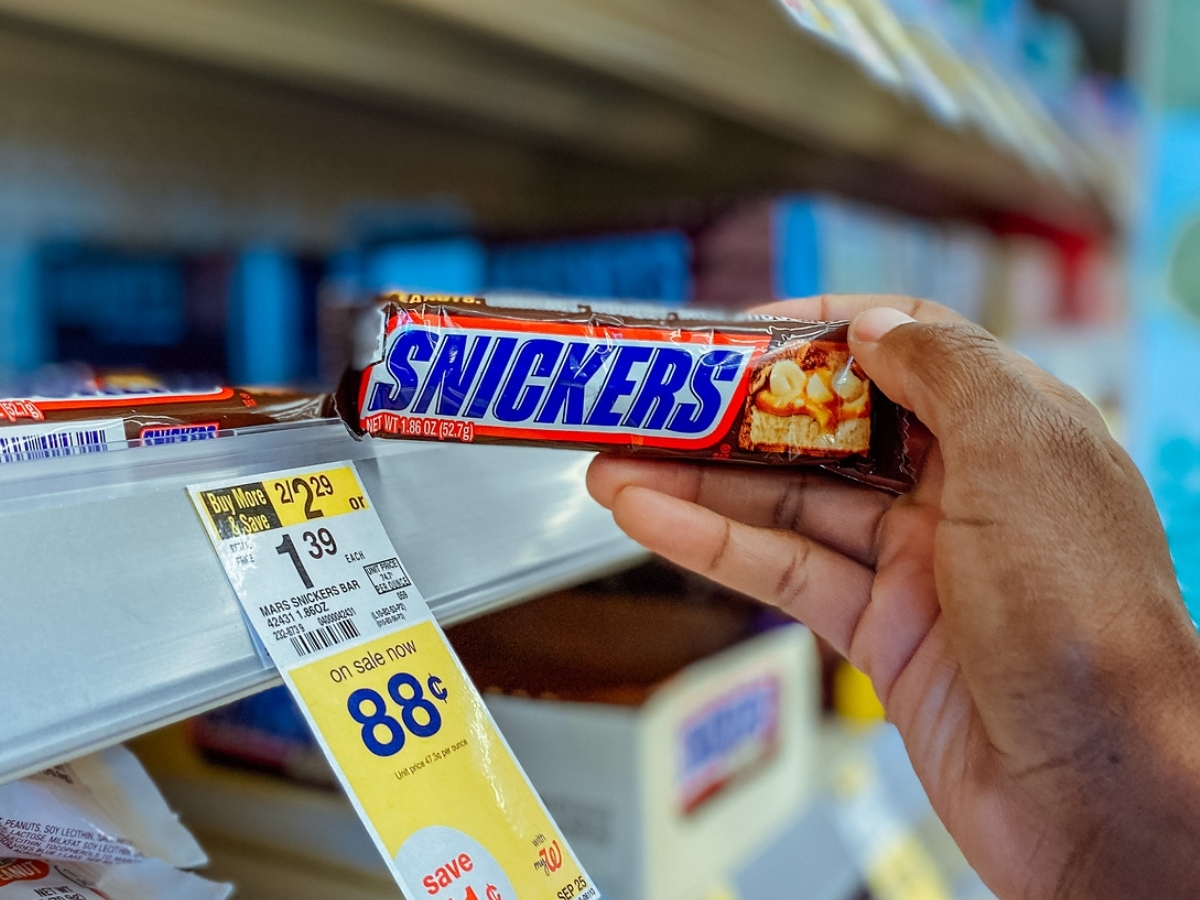 hand holding snickers bar