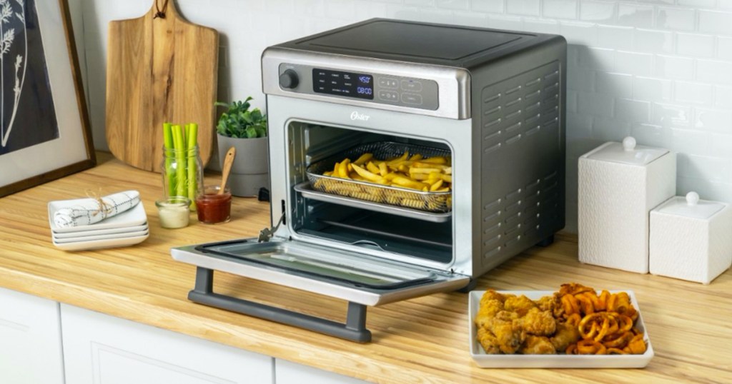stainless steel air fryer oven on kitchen counter with fries inside