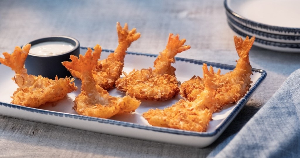 coconut shrimp with dip on rectangular plate