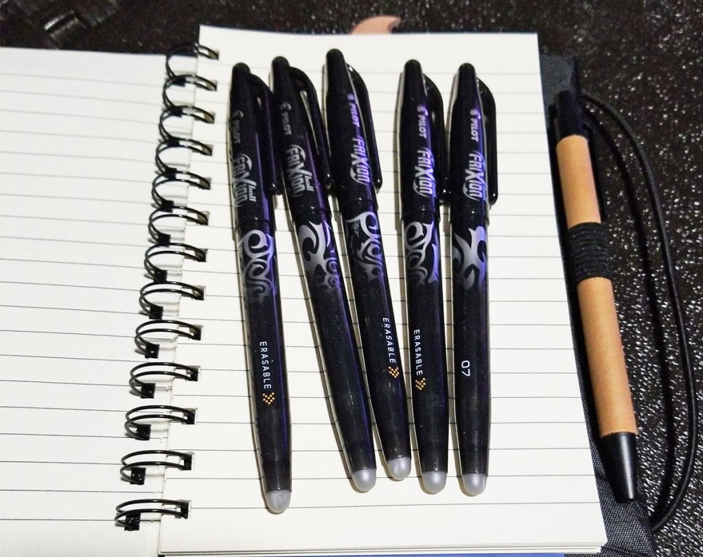 black Pilot FriXion pens on notebook