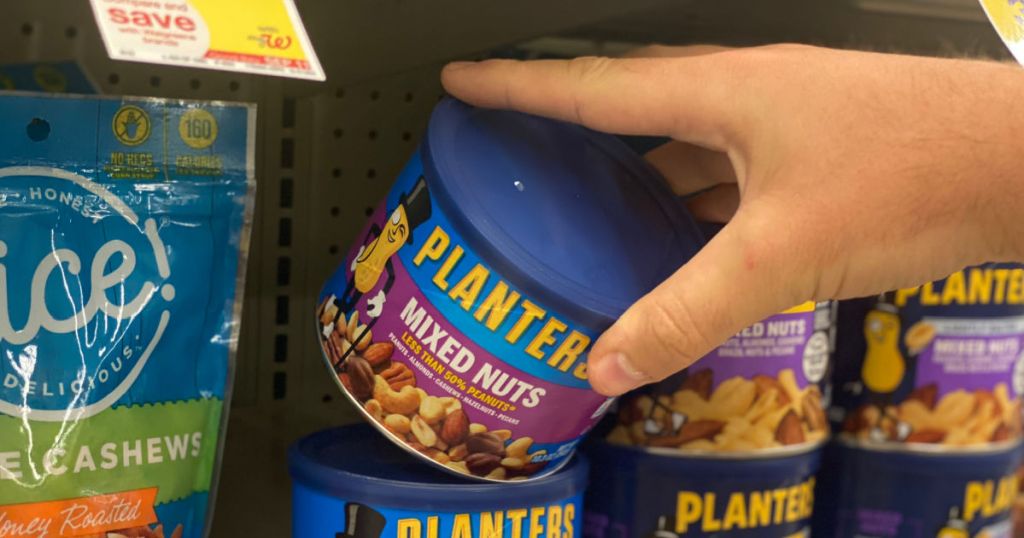 hand grabbing blue canister of nuts