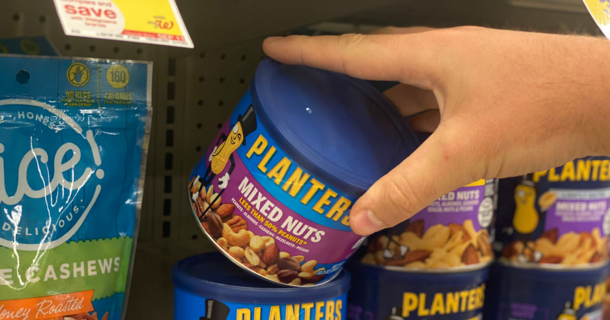 hand grabbing blue canister of nuts