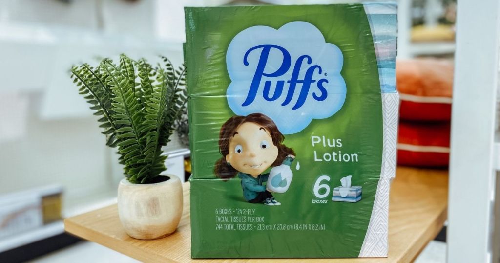 box of Puffs Plus Lotion next to a plant