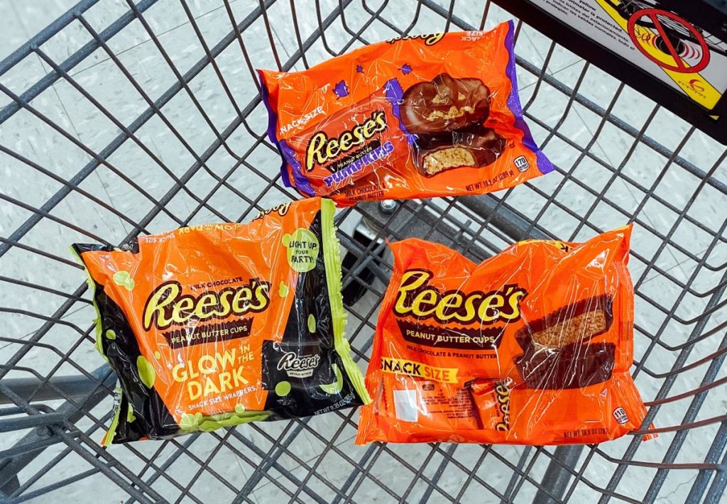three bags of Reese's candy in a cart
