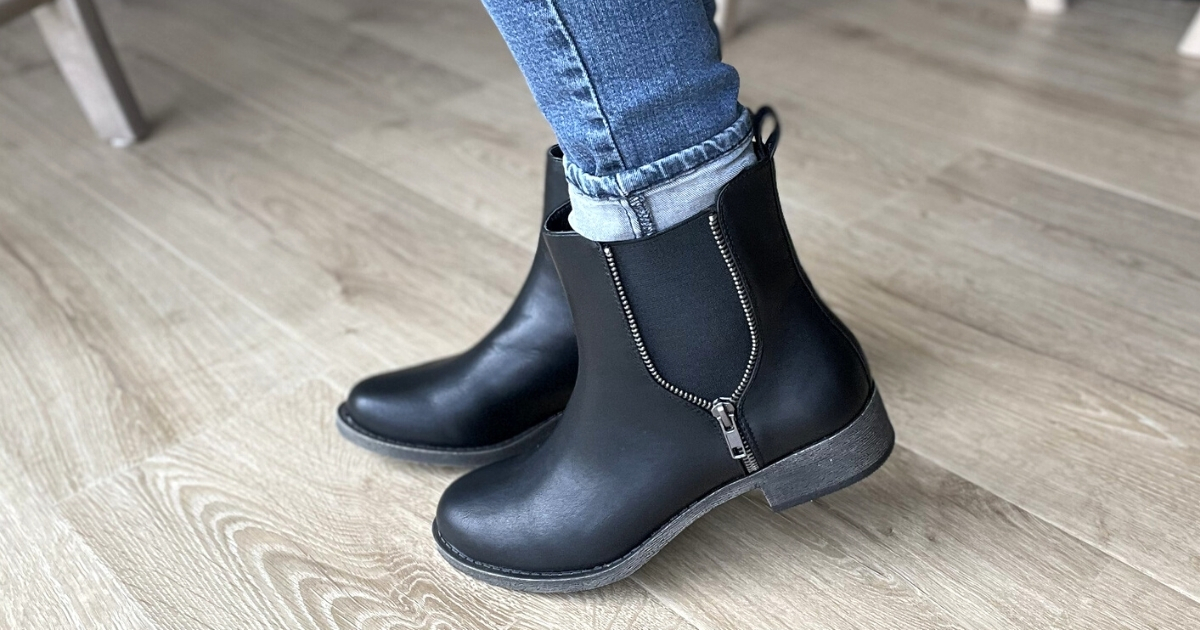 person wearing a pair of black Rocket dog boots