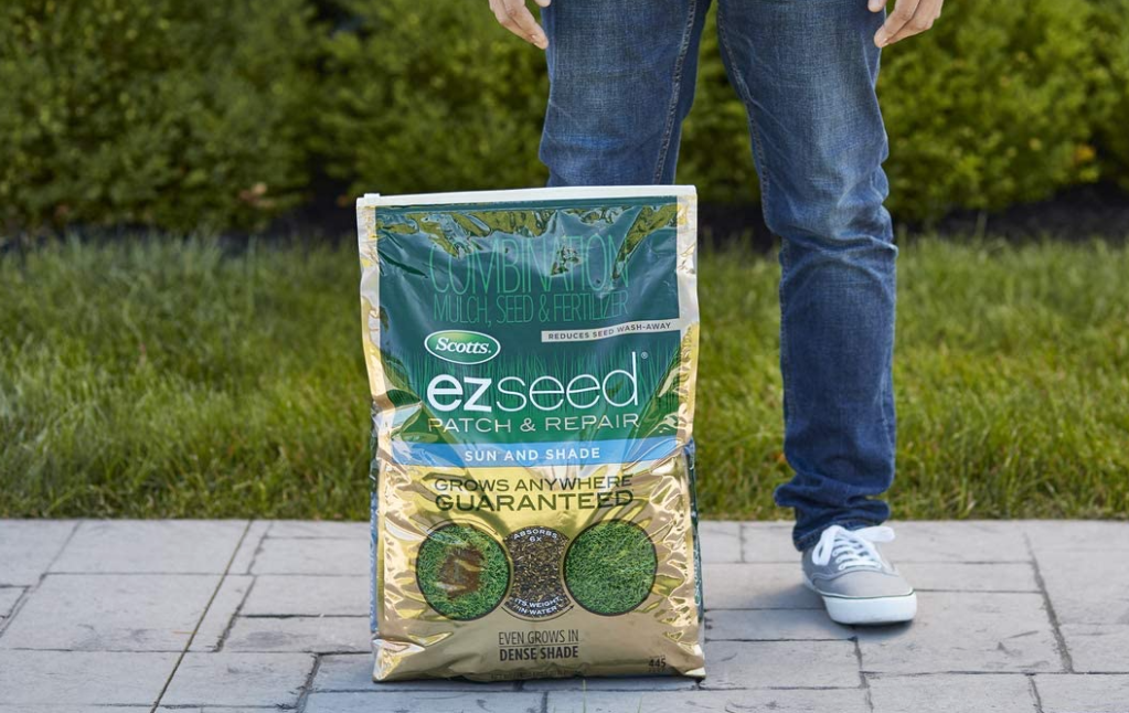person standing by a bag of Scotts EZ Seed Path and Repair