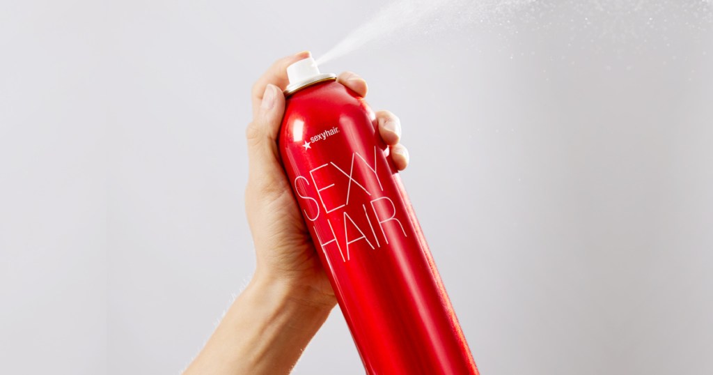big sexy hairspray in hand spraying