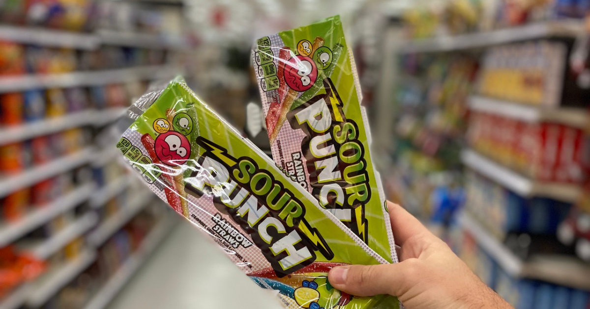 Man's hand holding two Sour Punch Straw packs