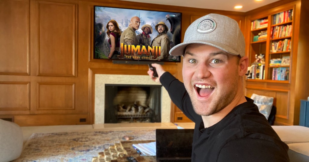 man very excited to watch Jumanji on his TV