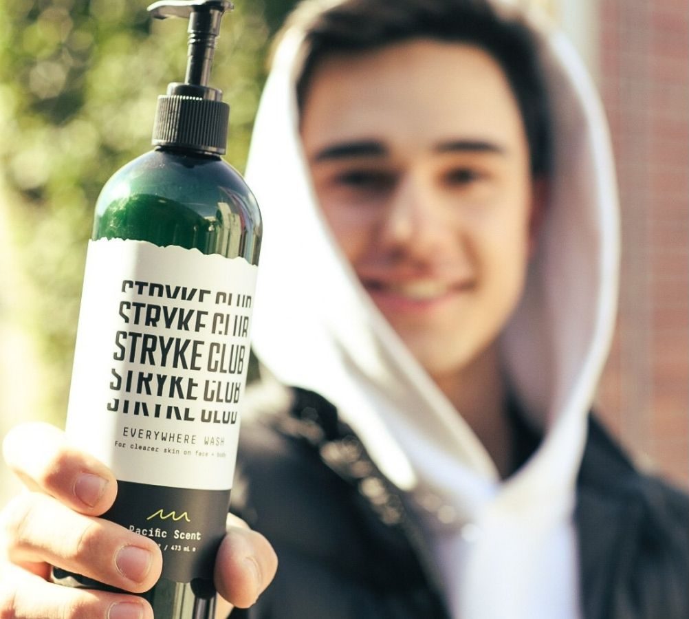 teen boy holding Stryke Club Wash