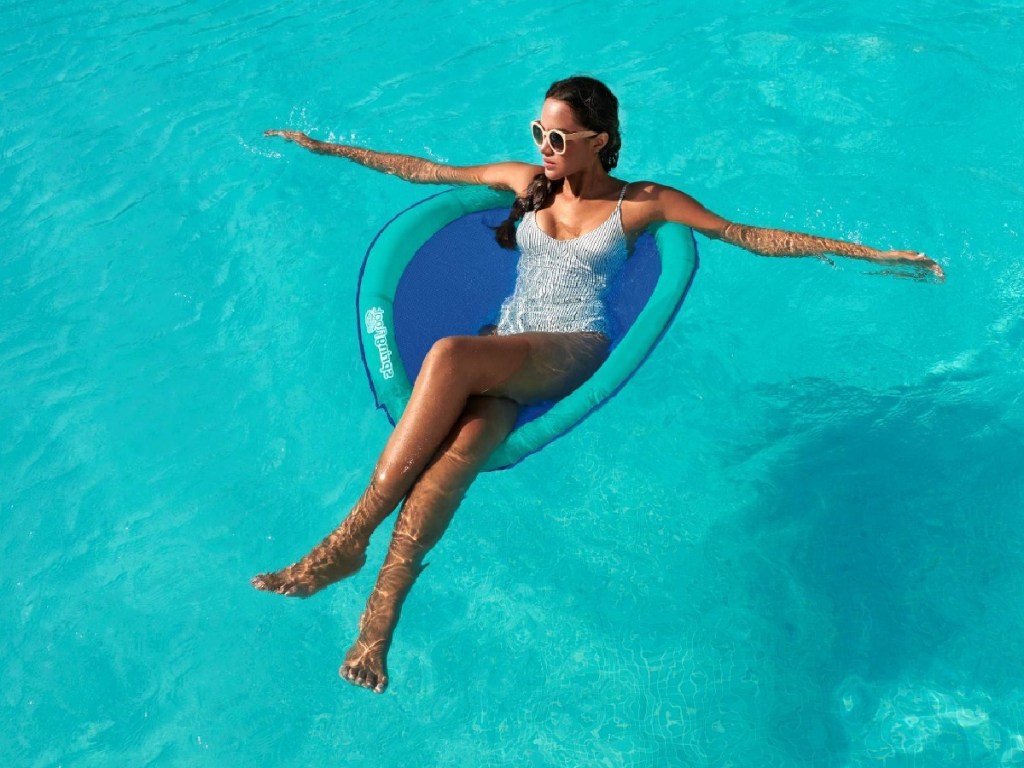 woman sitting in inflatable chair float in pool