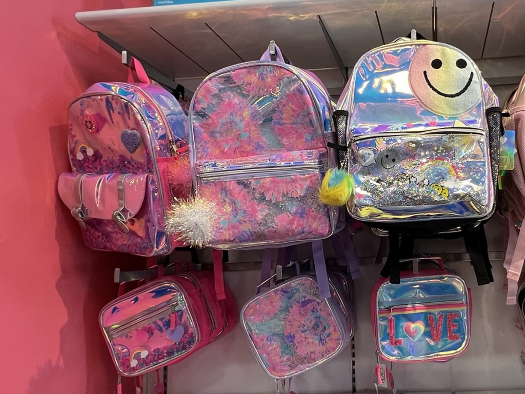 sparkly pink backpacks and lunch boxes on display in store
