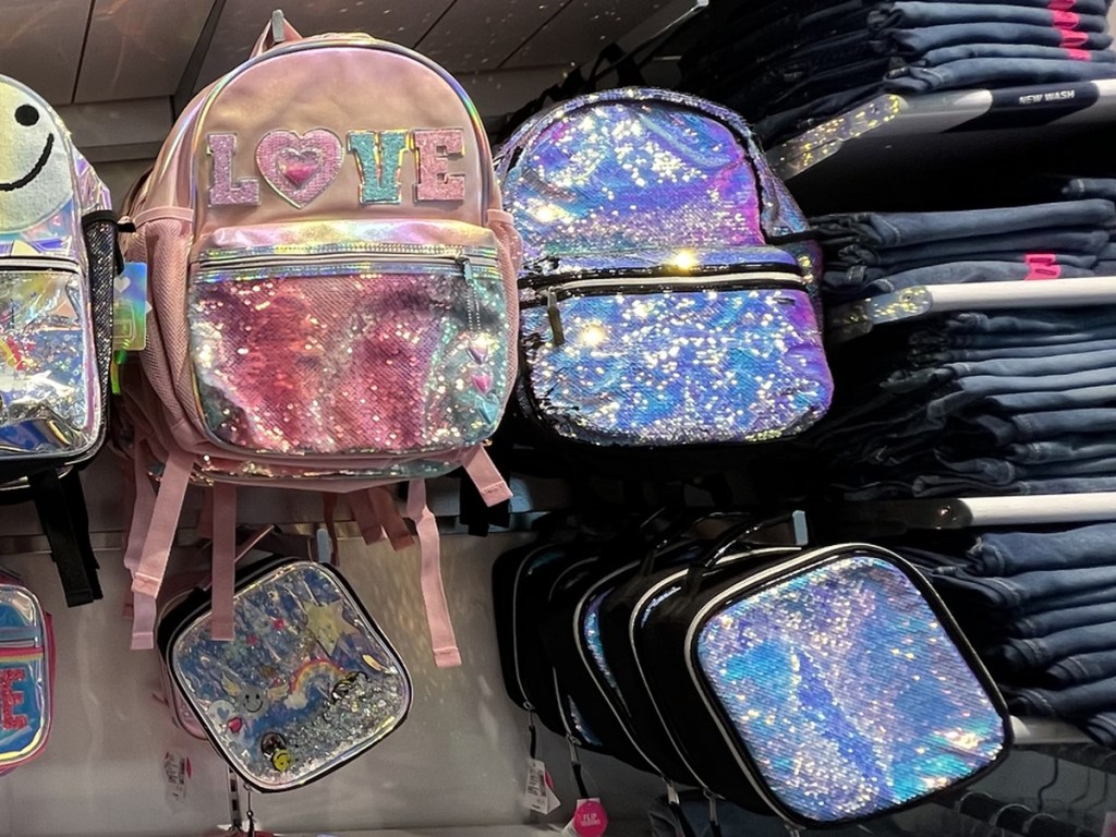 sparkly backpacks and lunch boxes on display in store