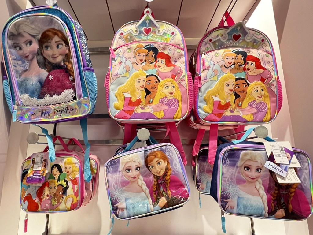 matching disney backpacks and lunch boxes on display in store