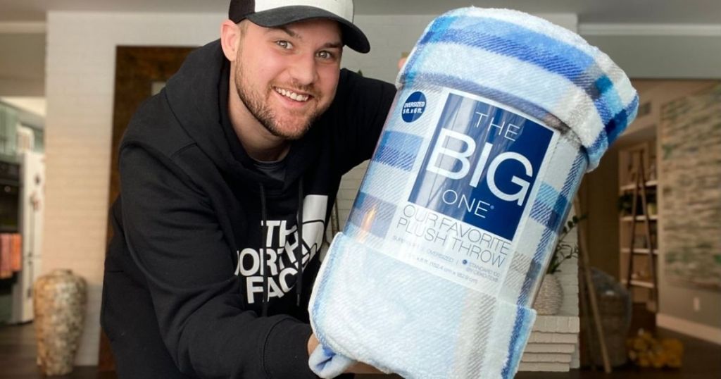 man holding package The Big One throw blanket