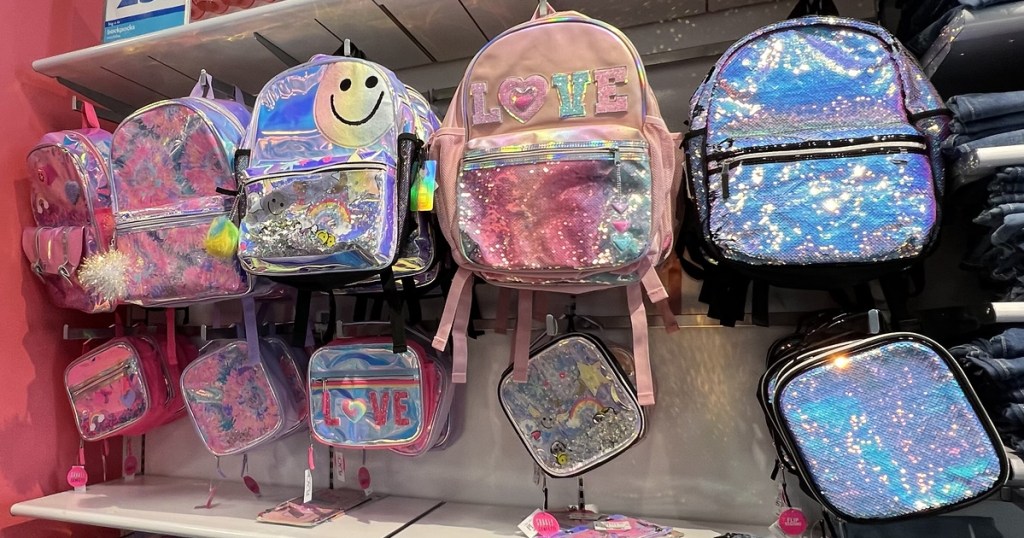 sparkly pink backpacks and lunch boxes on display in store