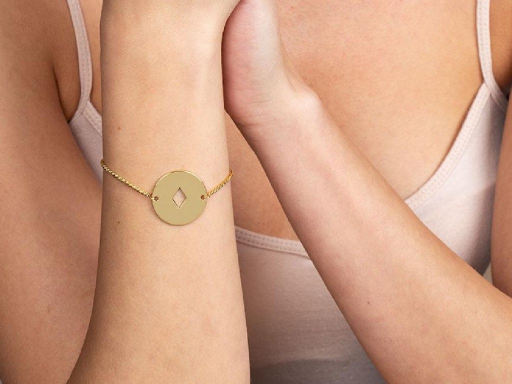 woman wearing a gold tone uncommon james bracelet