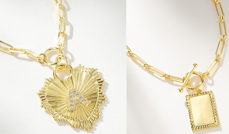 Two gold-tone necklaces with paperclip chains, one featuring a textured sunburst heart pendant with a pav&eacute;-set initial A and the other featuring a toggle clasp and rectangular tag pendant.
