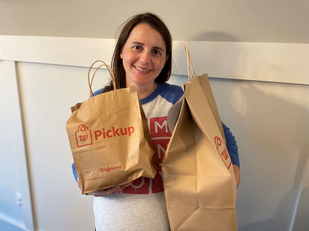 woman holding two Walgreens Pickup Bags