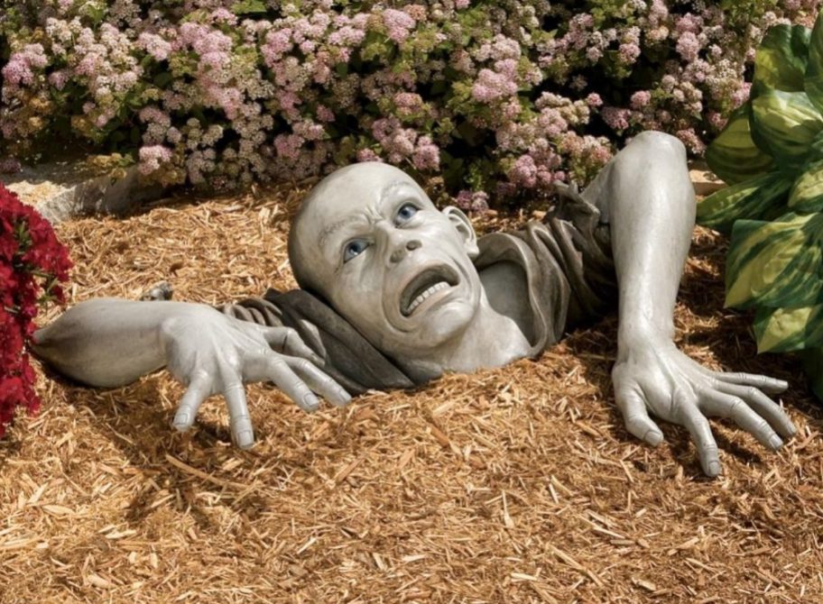 Zombie Statue coming out of the ground, depicting one of the strange and weird scholarships, the Zombie Apocalypse Scholarship