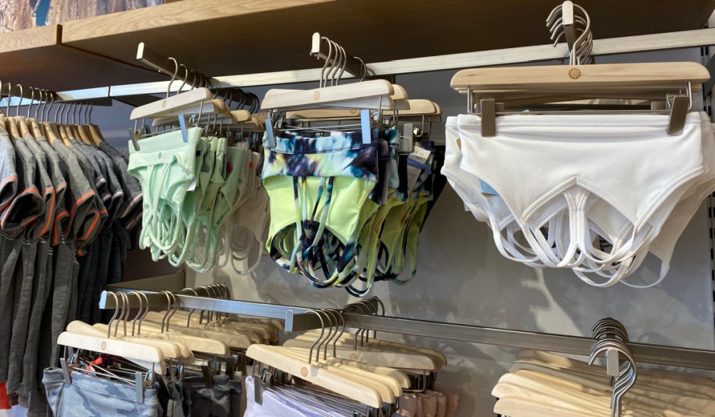 swim tops on hangers in store