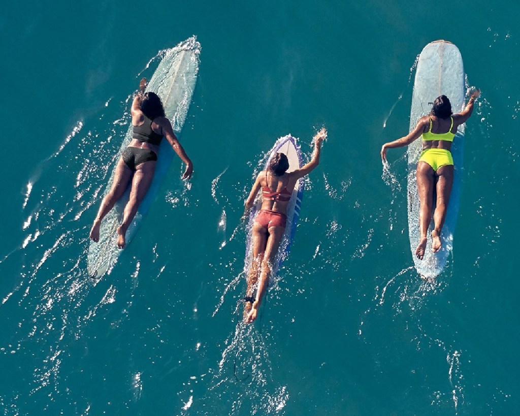 women on surfboards in ocean