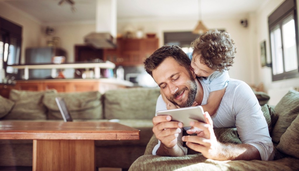 father and child looking at phone