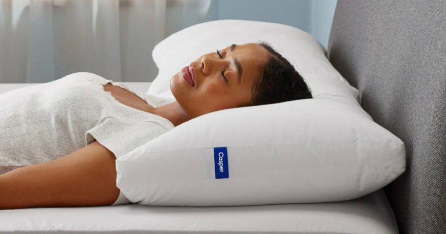 woman laying down on white casper pillow