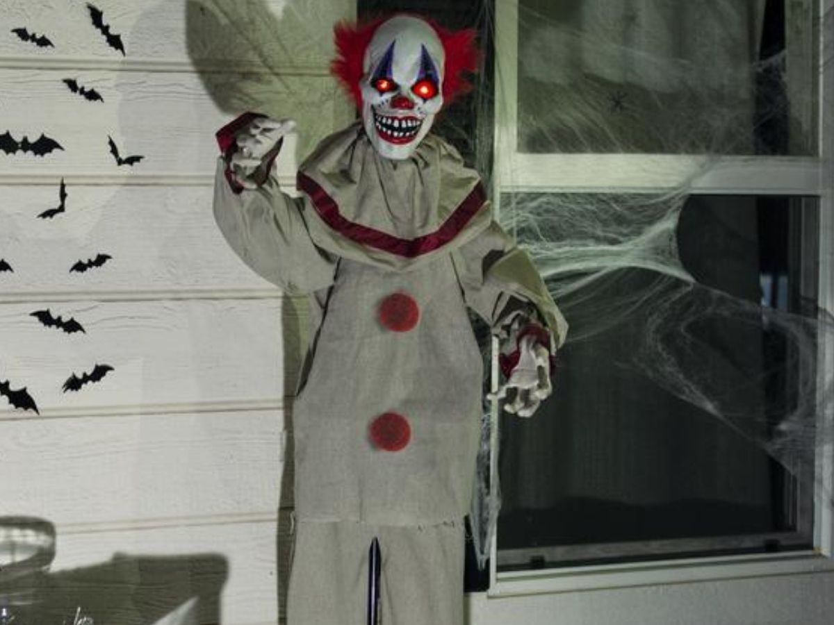 scary clown halloween decoratoin on porch