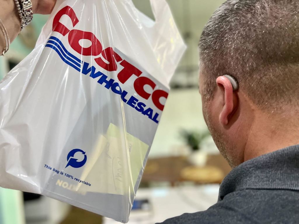 costco wholesale shopping bag next to man with hearing aid