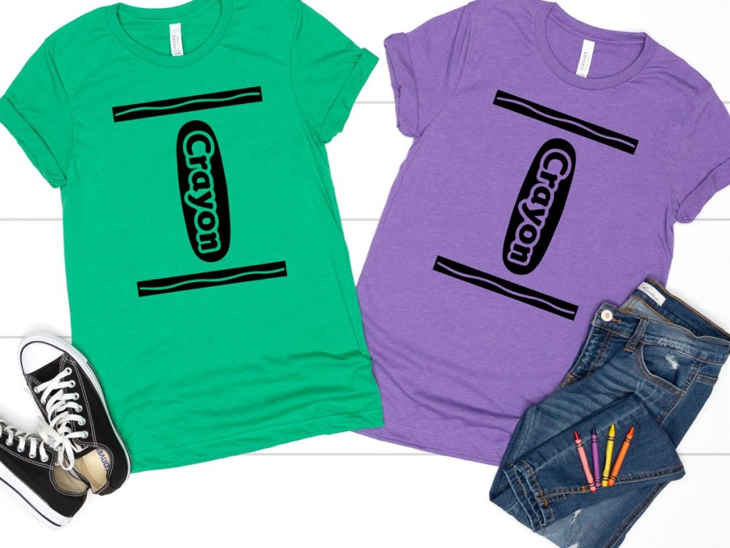 2 shirts with the Crayola logo next to jeans and shoes