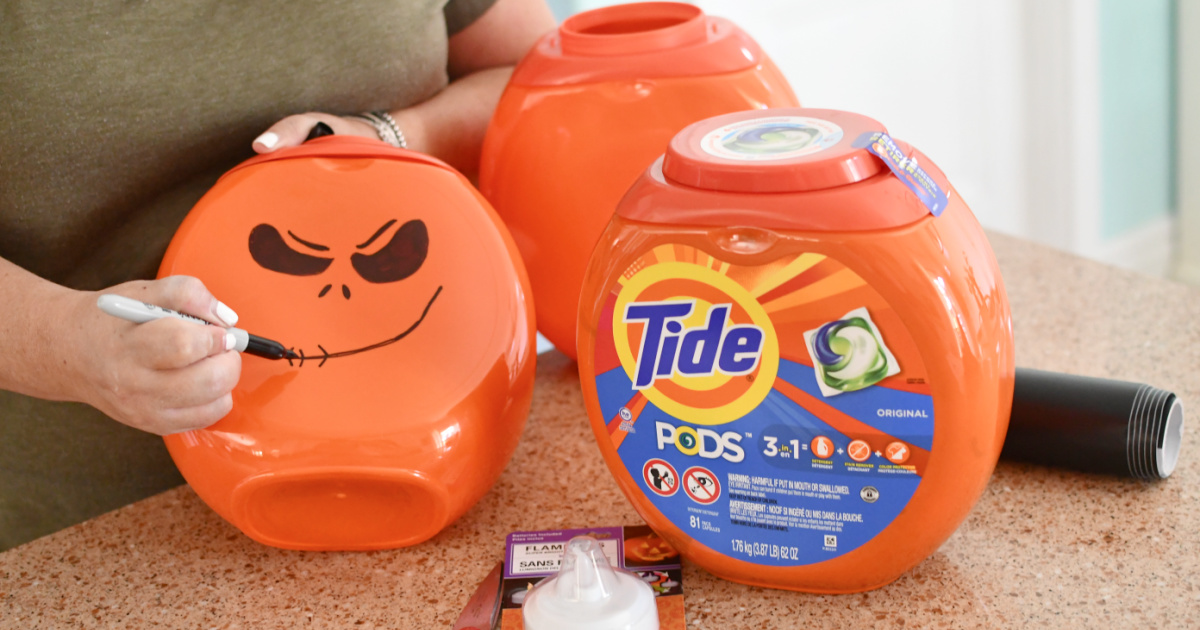 drawing-pumpkin-face-on-tide-pod-container- استخدم حاوية كبسولات الغسيل لعمل زينة للهالوين