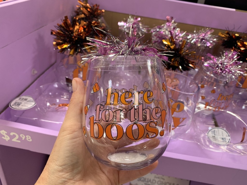holding a Halloween wine glass