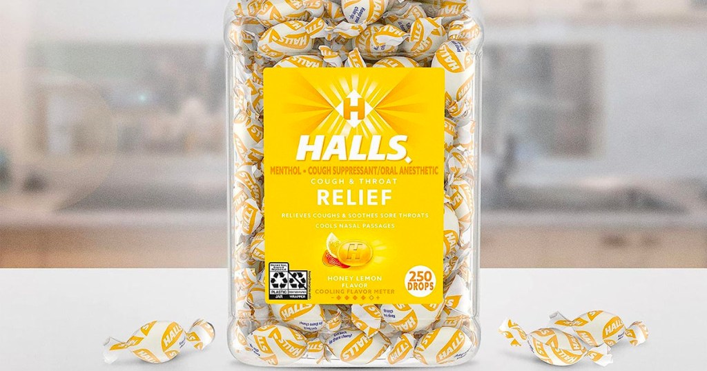 halls honey lemon cough drops in jar on counter