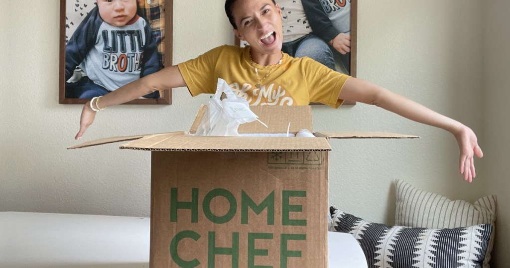 woman standing with home achef meal box