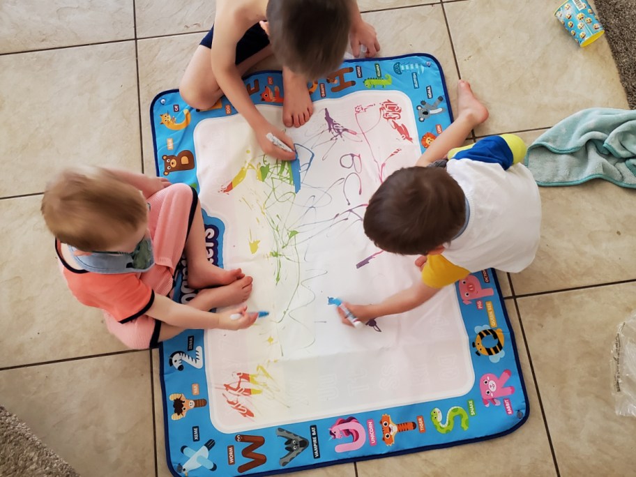 kids drawing on a water doodle at