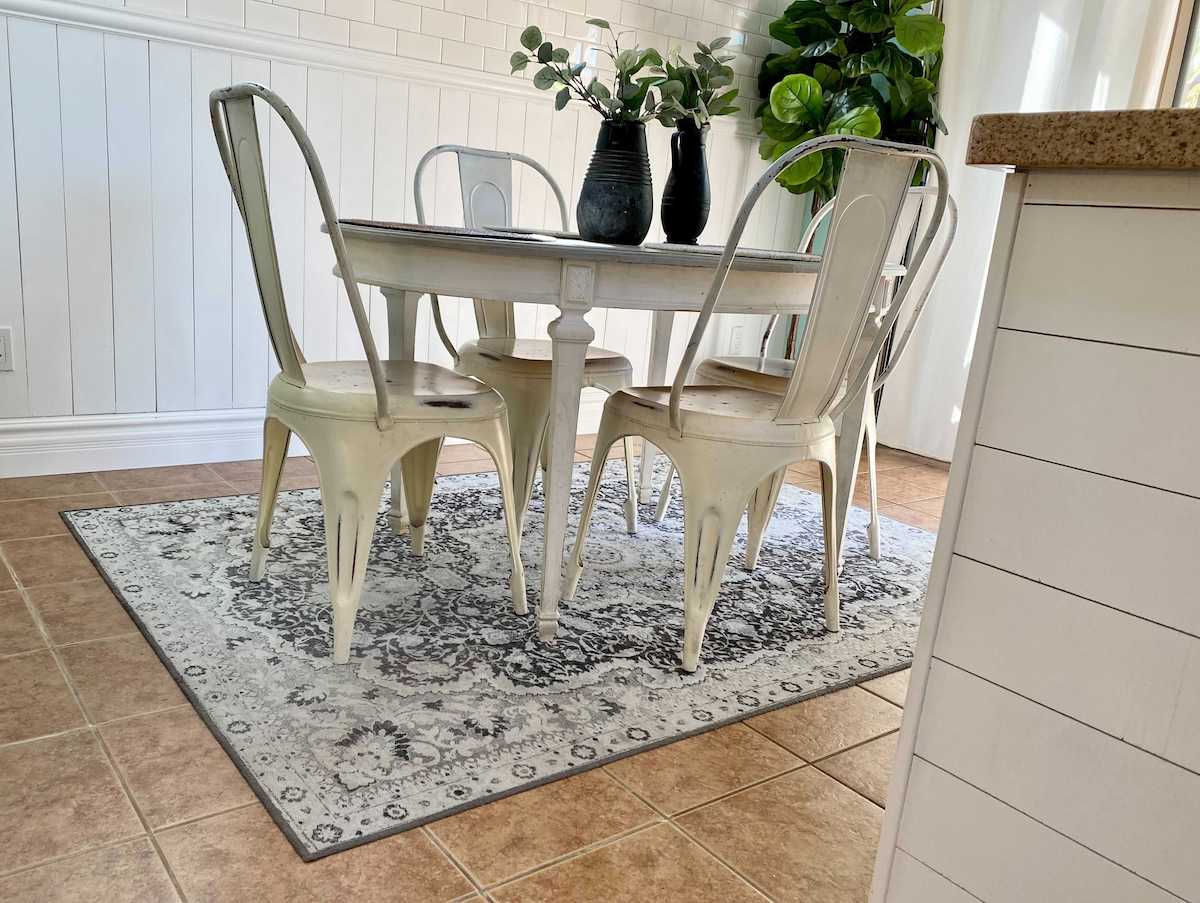 dining room with table chairs and washable rug