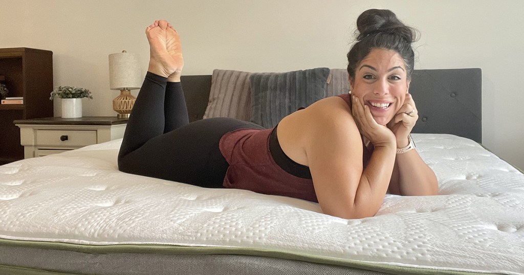 woman laying on bare mattress 