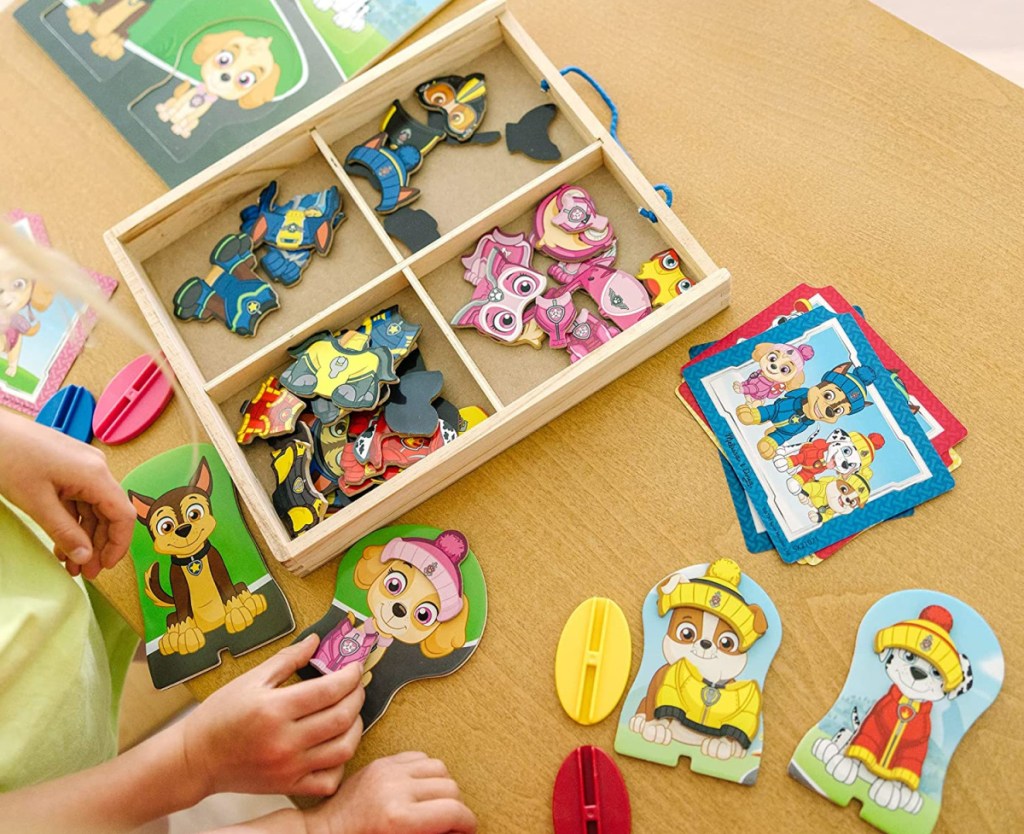 kids playing with a melissa doug magnetic dress up dolls set of paw patrol characters