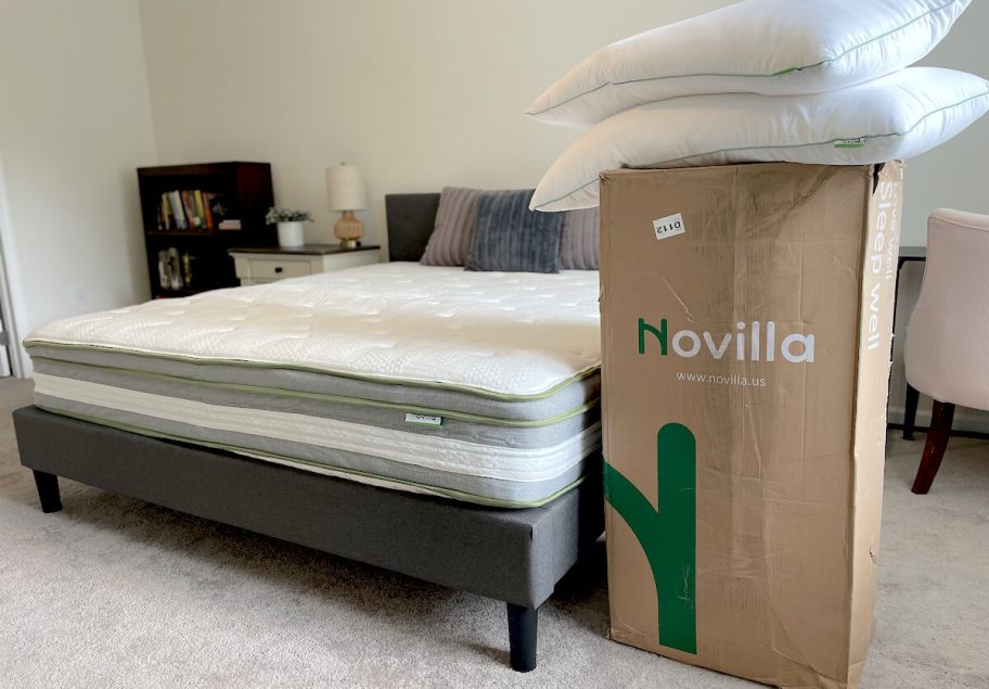 bare mattress and box on floor with pillows on top
