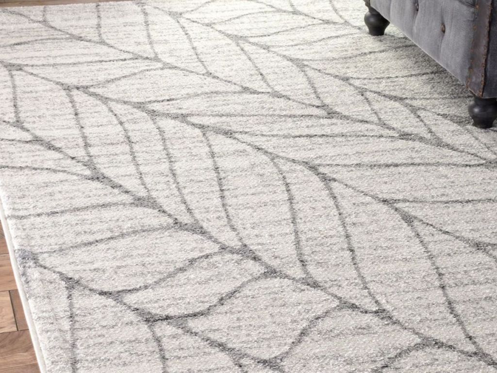 gray and white leaf area rug