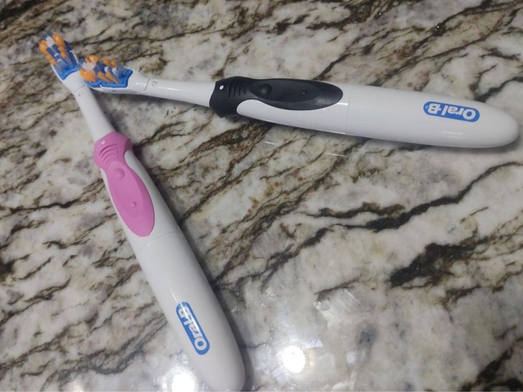 pink and black oral b toothbrushes