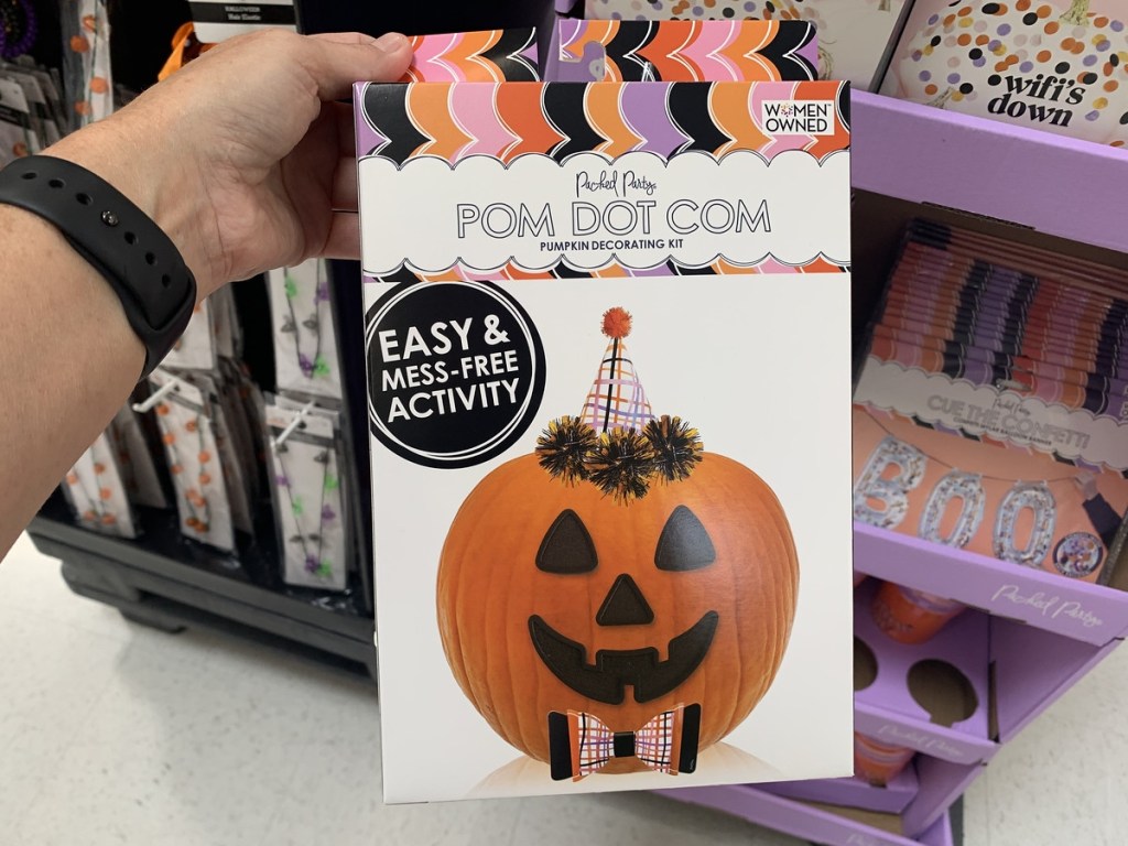 holding a pumpkin decorating kit
