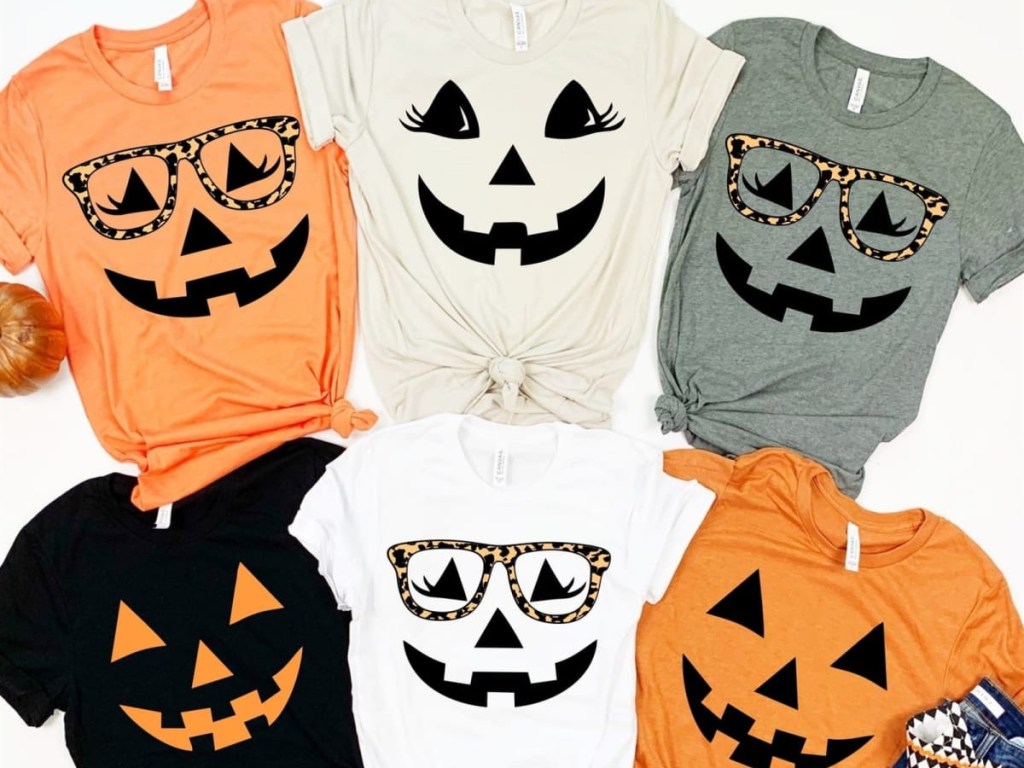six different colored tees with pumpkin designs