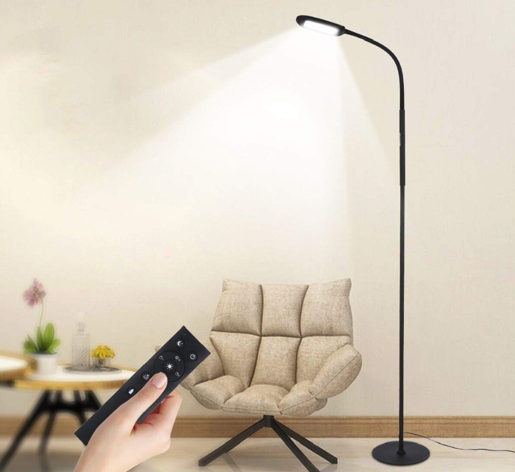 standing floor lamp with remote in hand