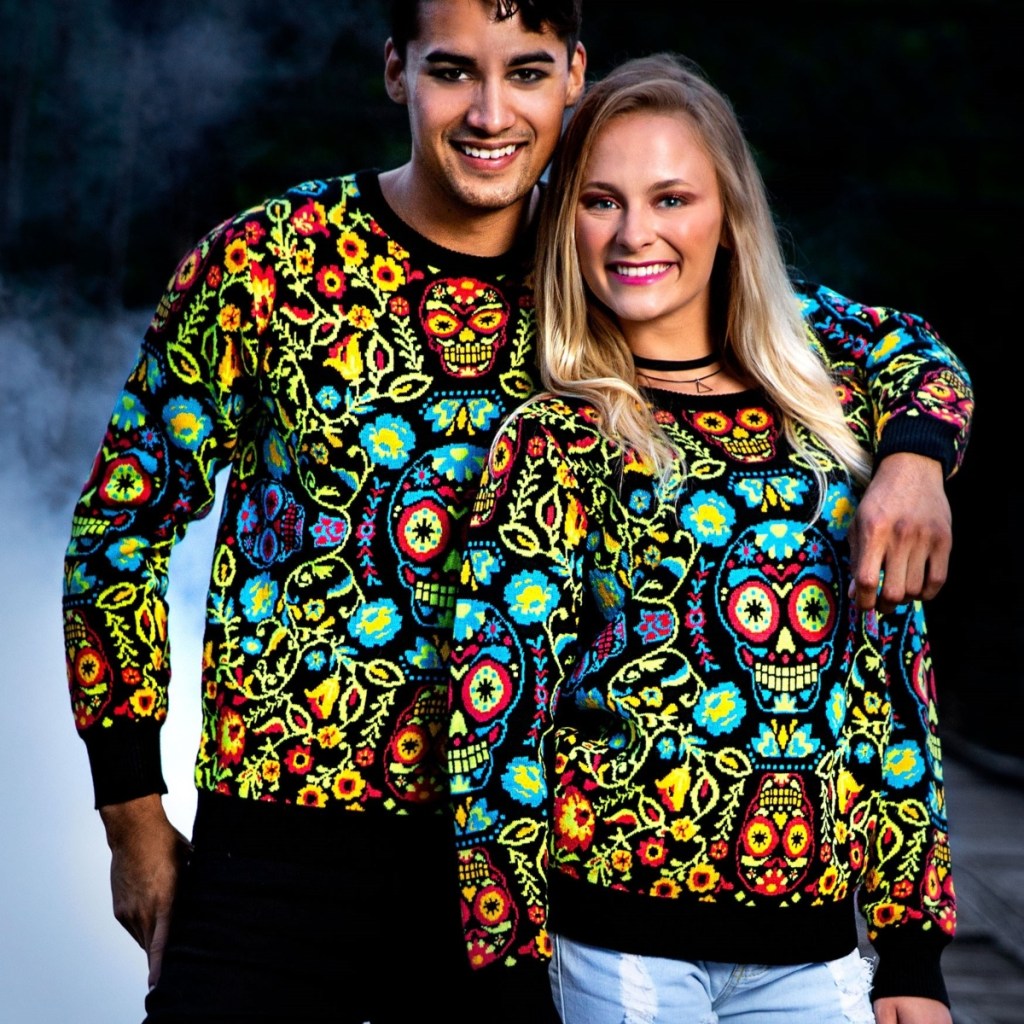 couple wearing sugar skull sweaters
