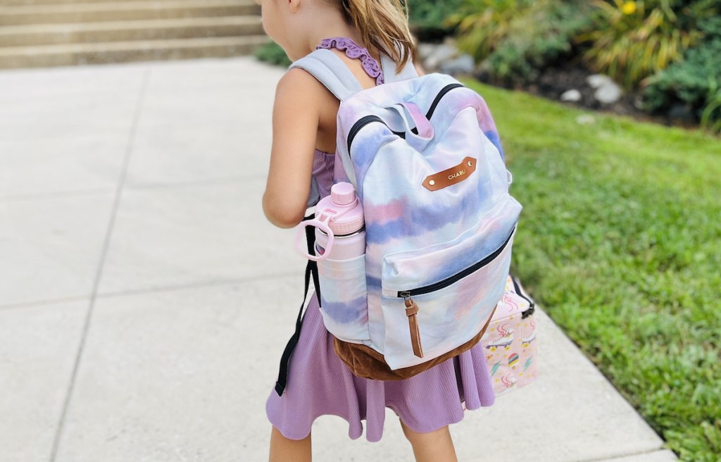 girl walking to school with tie dye backpack 