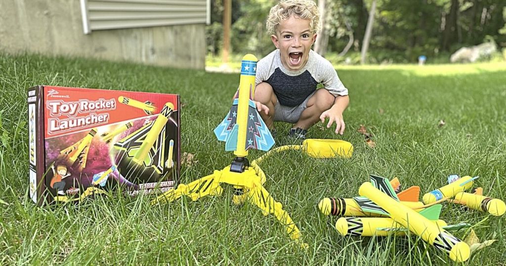 kid sitting behind Toy Rocket Launcher