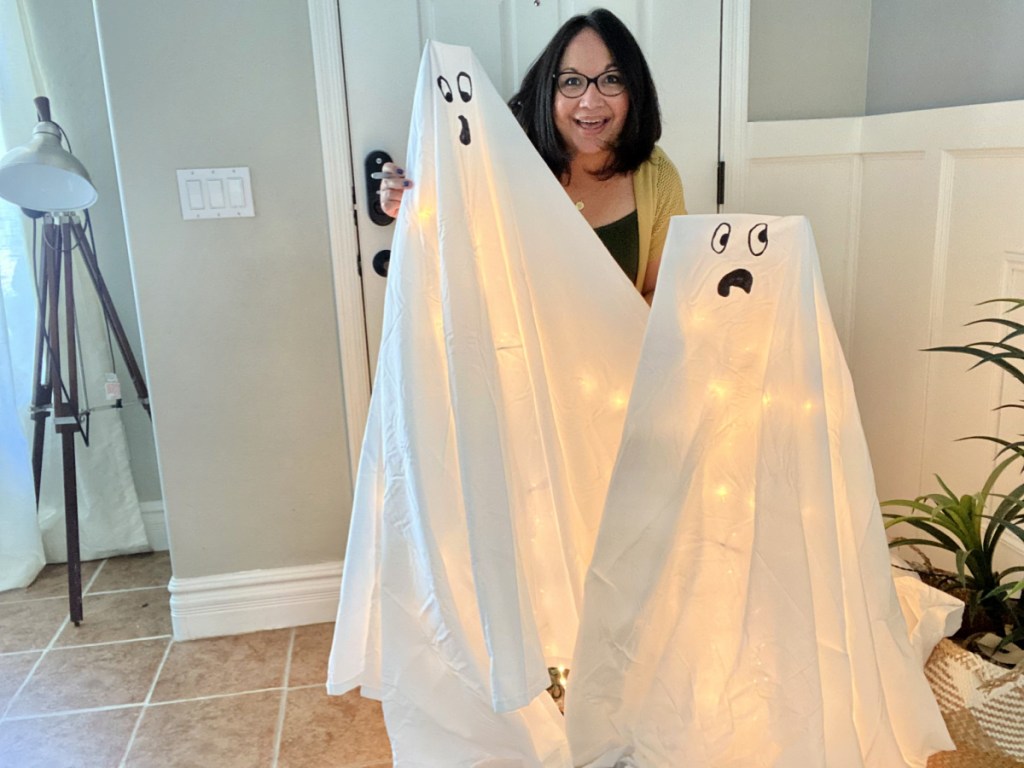 woman making tomato cage Halloween ghost decorations